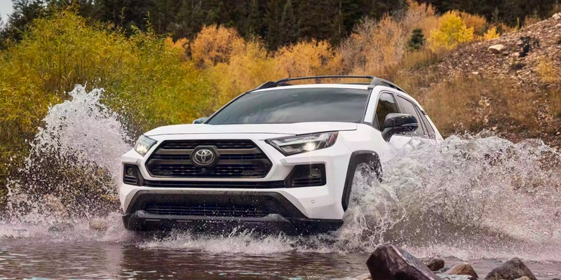 White 2024 Toyota RAV4 driving through water in Roseville, CA