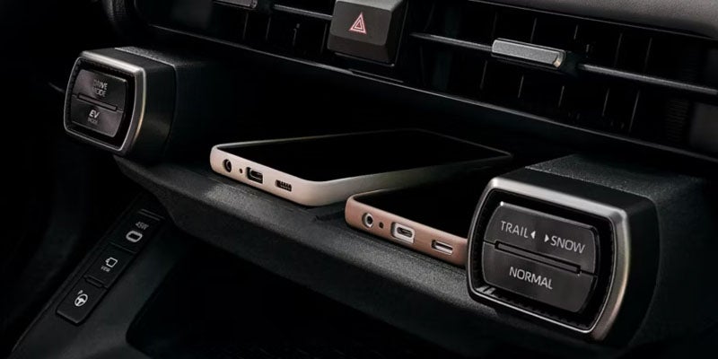 Car interior center console with drive mode selector and infotainment controls.