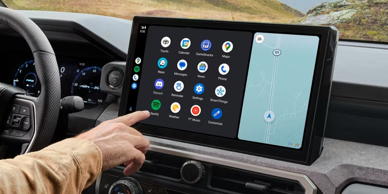 Toyota Tacoma infotainment touchscreen with app icons and navigation map being used.